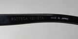 Close-up of Bottega Veneta Bv6505j Eyeglasses frame showing logo and 'Made in Japan' inscription.