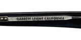 Close-up of Garrett Leight Lo-B Sunglasses detailing, showcasing the brand name on the temple.